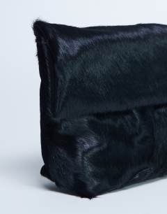 Model wearing Georgia leather folded clutch grab bag in black pony
