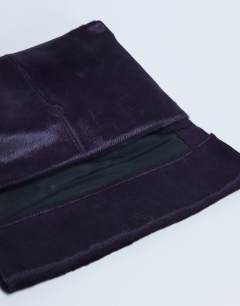Model wearing Georgia leather folded clutch grab bag in purple pony