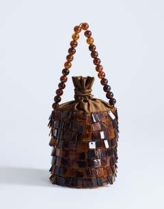 Model wearing Georgie embellished grab bucket bag in brown tort