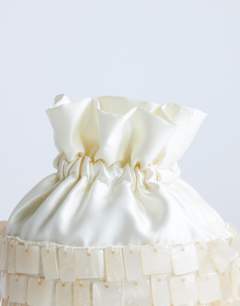 Model wearing Georgie embellished grab bucket bag in ivory