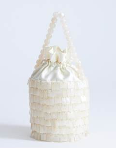 Model wearing Georgie small embellished grab bucket bag in ivory