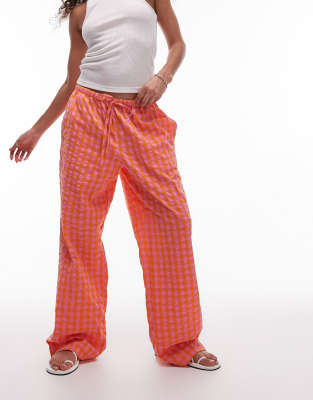 Topshop - Geruite broek met elastische taille in oranje