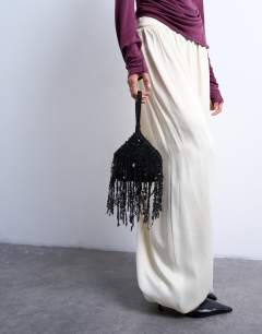 Model wearing Giana sequin tassel grab bag in black