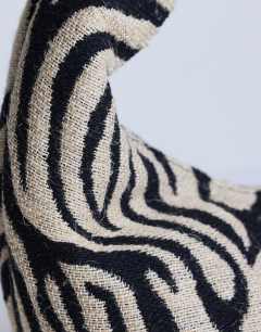 Model wearing Giane canvas zebra scoop bag in black