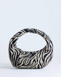 Model wearing Giane medium canvas zebra scoop bag in black