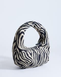 Model wearing Giane medium canvas zebra scoop bag in black