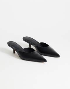 Model wearing Gigi kitten heel court shoe in black