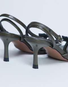 Model wearing Gilly heeled toe thong with metal detail in khaki
