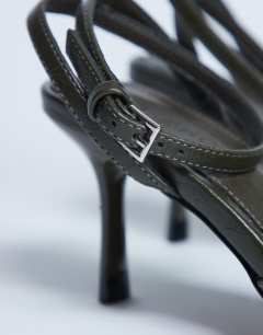 Model wearing Gilly heeled toe thong with metal detail in khaki