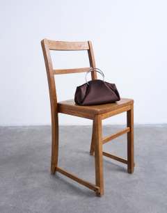 Model wearing Ginny metal handle grab bag in chocolate