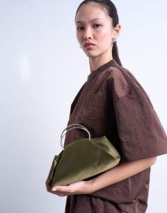 Model wearing Ginny metal handle grab bag in khaki