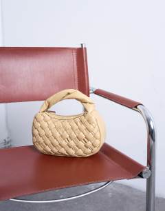 Model wearing Gladys woven grab bag in buttermilk