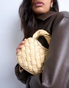 Model wearing Gladys woven grab bag in buttermilk