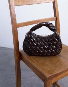 Model wearing Gladys woven grab bag in chocolate