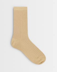 Model wearing Glitter socks in gold
