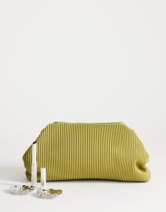 Model wearing Golde medium clutch bag in green