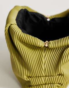 Model wearing Golde medium clutch bag in green