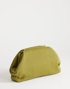 Model wearing Golde medium clutch bag in green