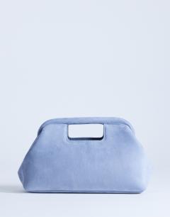 Model wearing Gordan clutch with handle in blue