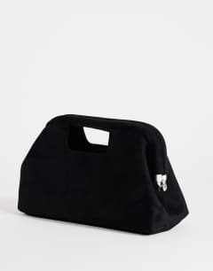 Model wearing Gordan medium suedette clutch with handle in black