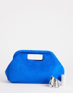 Model wearing Gordan medium suedette clutch with handle in cobalt
