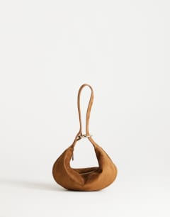 Model wearing Grace small faux suede scoop grab bag in tan