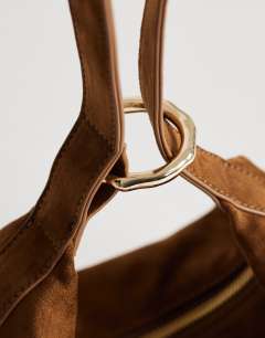 Model wearing Grace small faux suede scoop grab bag in tan