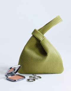 Model wearing Gracie grab bag in chartreuse