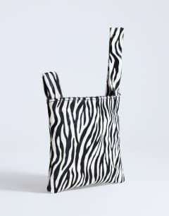 Model wearing Gracie hair on leather grab bag in zebra 