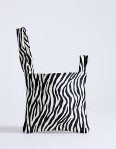 Model wearing Gracie small hair on leather grab bag in zebra