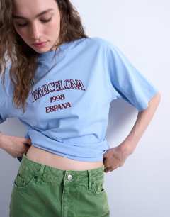 Model wearing Graphic Barcelona oversized tee in blue