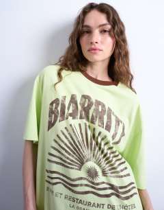 Model wearing Graphic biarritz oversized ringer tee in green