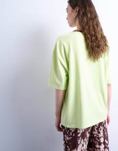 Model wearing Graphic biarritz oversized ringer tee in green