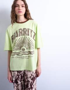 Model wearing Graphic biarritz oversized ringer tee in green