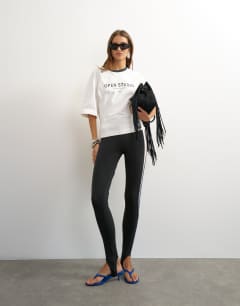 Model wearing Graphic cinched waist piping detail in ecru