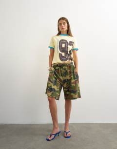 Model wearing Graphic colour block cuff tee in yellow