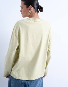 Model wearing Graphic Giardino Iris skater tee in green