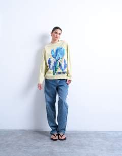 Model wearing Graphic Giardino Iris skater tee in green