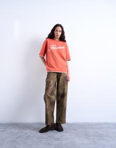 Model wearing Graphic Havana oversized whip stitch tee in orange