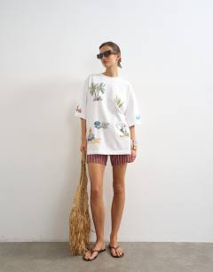 Model wearing Graphic holiday doodle print oversized tee in white