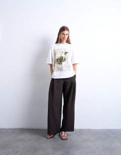 Model wearing Graphic martini print oversized tee in ivory