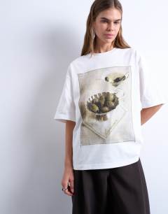 Model wearing Graphic martini print oversized tee in ivory