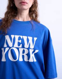 Model wearing Graphic New York oversized tee in cobalt blue