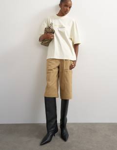 Model wearing Graphic 'No. 1' oversized t-shirt in ecru