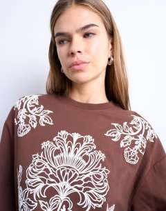 Model wearing Graphic paisley long sleeve skater tee in brown