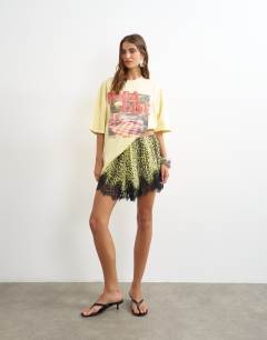 Model wearing Graphic Paradise short sleeved t shirt in yellow