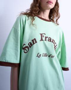 Model wearing Graphic San Francisco oversized tee in green