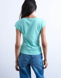 Model wearing Graphic Tropez cap sleeve slash neck baby tee in teal