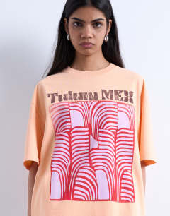 Model wearing Graphic Tulum oversized tee in orange
