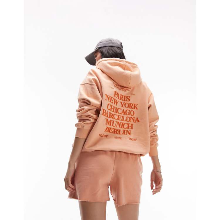 Topshop graphic vintage wash city oversized hoodie in peach